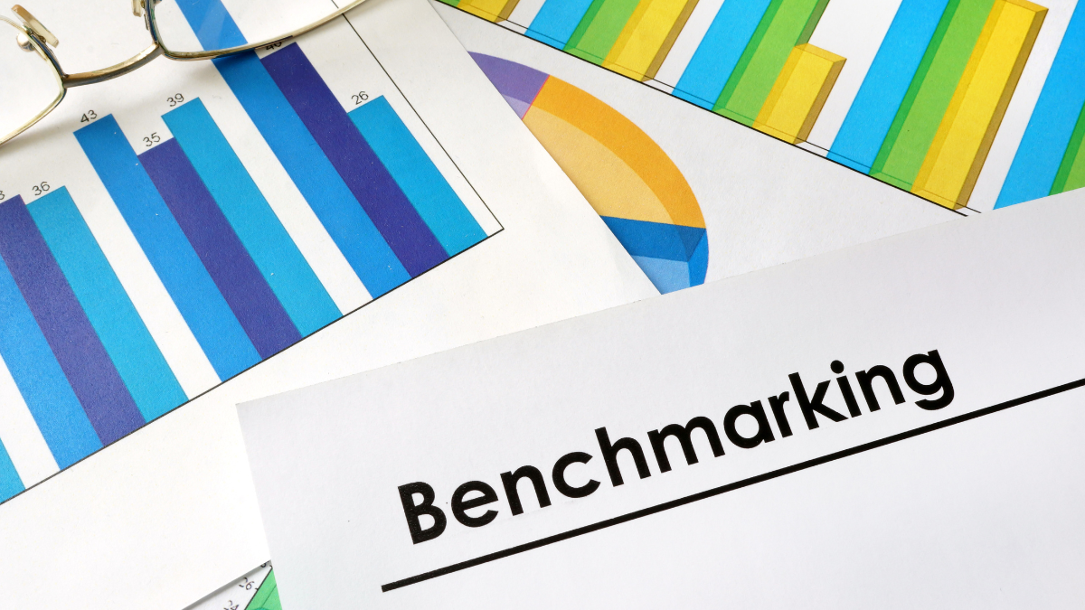 Financial charts and graphs surrounding a document titled "Benchmarking”